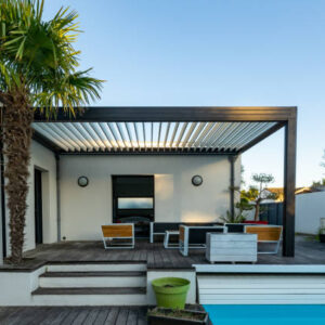 Trendy outdoor patio pergola shade structure, awning and patio roof, garden lounge, chairs, metal grill surrounded by landscaping